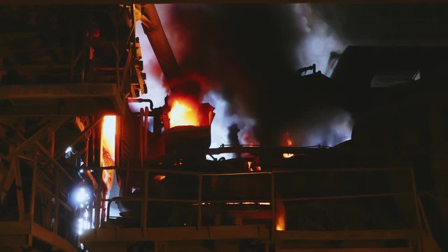 Steel production in a steelmaking furnace. Metallurgy. Casting ingot. Electric arc furnace shop. Shop EAF. Plant for the production of steel. An electric melting furnace. Close up.