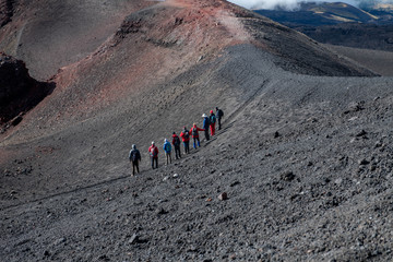 Landscape with Group of Hikers on Mount Etna with Black and Red Rocky Surface