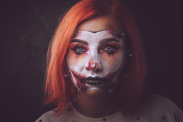 Closeup photo shoot of woman's face with creative scary makeup for Halloween.