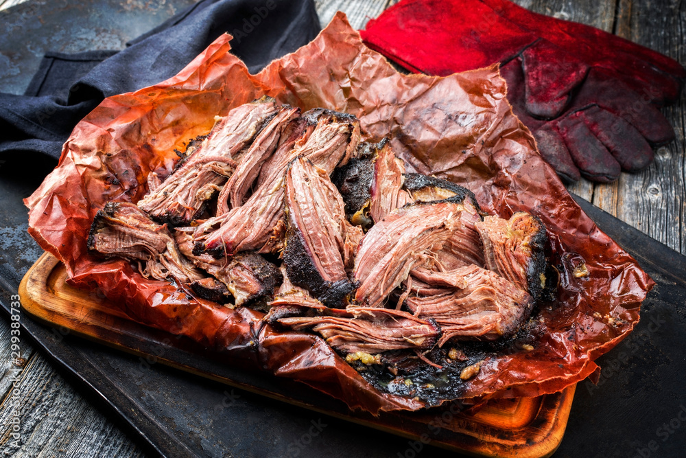 Canvas Prints Traditional barbecue wagyu pulled beef in peach paper as closeup on a rustic board - Canvas Prints