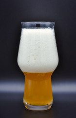 glass of beer on black background, filled glass, drink on black background, glass with a foamy drink