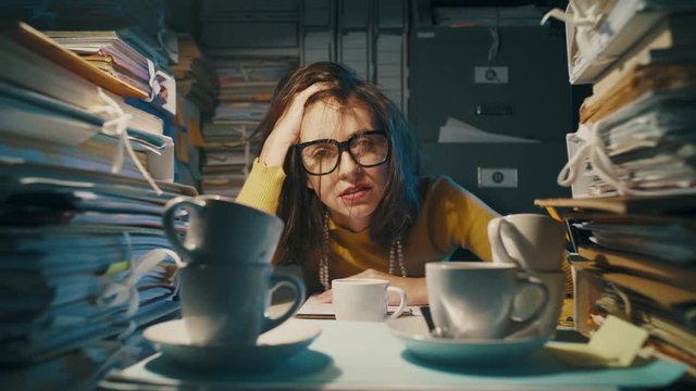 Exhausted stressed office worker having too many coffees
