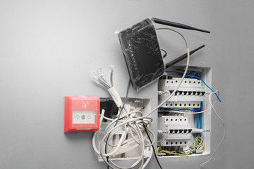 Electrical switchboard with unconnected wires. Circuit breakers with a fire alarm button and a home...