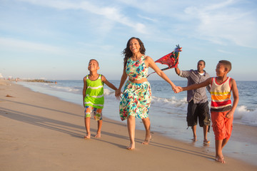 happy family at the beach flying a kite