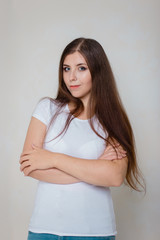 portrait of a young girl in a white t-shirt on a white background