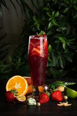 lemonade with cranberries and citruses in a tall glass