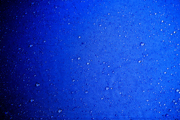 Obraz premium Water drops on the blue fabric.water drops on blue background
