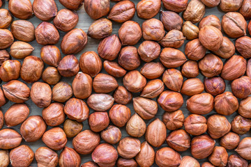 Unshelled hazelnuts background, top view