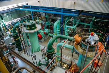 Worker repairs pipeline of water circulation in power plant