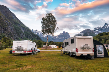 campers in campsite on sunset