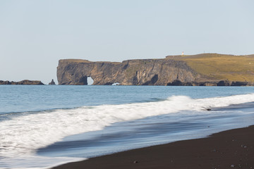 Fototapeta na wymiar View over Dyrholaey Cliffs from the Famous Black Beach of Reynisfjara, Iceland