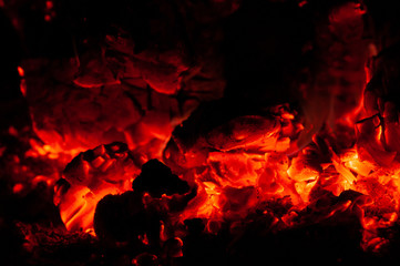 Bright colorful glowing orange-red embers bonfire.