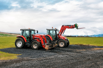 two red tractors in the field