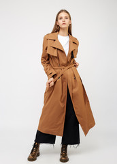 Female trench coat camel color isolated on white background.