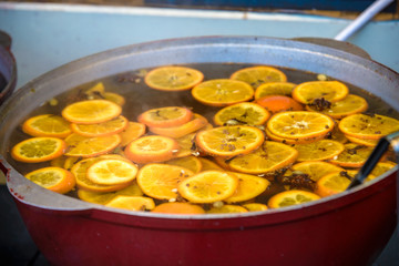 Traditional winter warming alcoholic drink - mulled wine. Hot wine with fruits and spices and ladle...