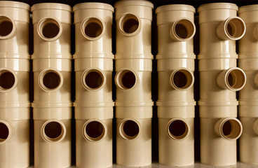 Sequence of stacked white plastic pipes