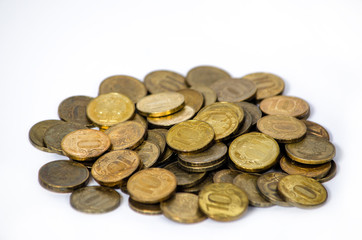 A pile of old and rusty Russian coins of 10 rubles lie on the table, isolated on a white background. Poor country with small salaries of the population. Little money. Copy space