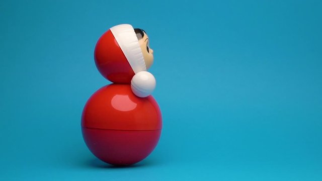 Roly poly children toy on blue background