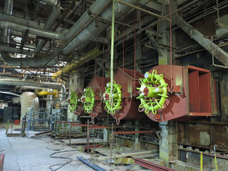 Giant gas-burners, glitter tubes, equipment, cables and piping inside a modern industrial power plant