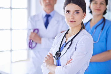 Group of doctors and nurses standing in a hospital room