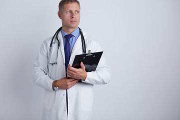 Male doctor standing with folder, isolated on white background