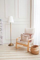 Scandinavian interior of a living room. Armchair and floor lamp