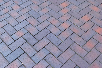 Paving slabs, stones of rectangular and square shapes of different colors laid out with patterns...