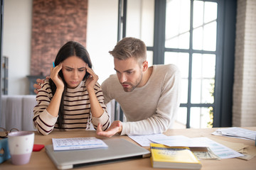 Husband supporting his wife filling tax documents