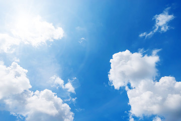 Background of clouds and sunlight against deep blue sky