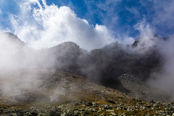 Mountain landscape in the autumn scenery. Clouds rolling across the ridge and the valley.