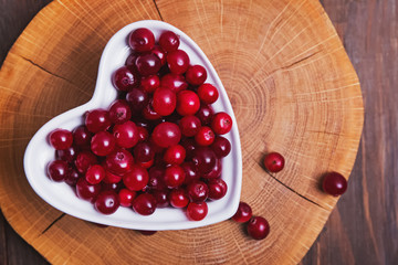 bowl of cowberries on old wooden table