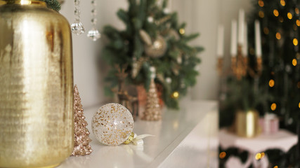 Christmas morning. Classic apartments with white interior, decorated tree, candles, christmas decor in gold color