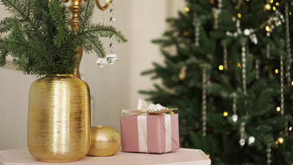 Christmas morning. Classic apartments with white interior, decorated tree, candles, christmas decor in gold color