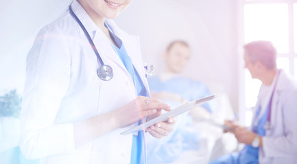 Female doctor using tablet computer in hospital lobby