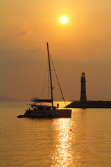 Seascape at sunset. Lighthouse on the coast. Seaside town of Turgutreis and spectacular sunsets