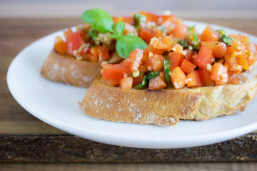 Food photography of classic Italian tomato bruschetta on a white plate