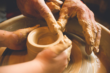 Children's hands make a mold of clay. Pottery