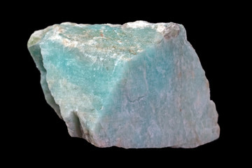 Rock of green amazonite mineral (or amazonstone) from Russia isolated on a pure black background.