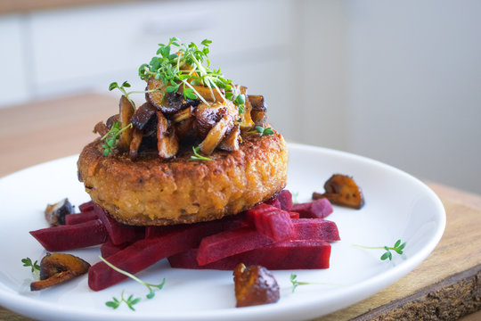 Food photography of the traditional danish dish frikadeller with beets and mushrooms