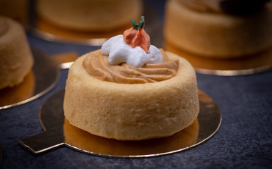 Cake shells filled with pumpkin spice cream, decorated  with chocolate leaves and little royal icing pumpkins