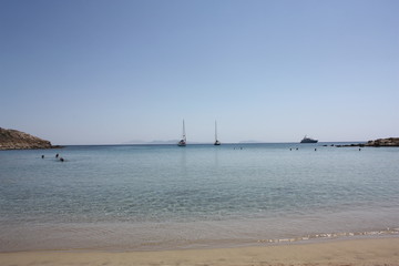 Aegean sea: sand, water, ripples, reflections, waves and lighthouses