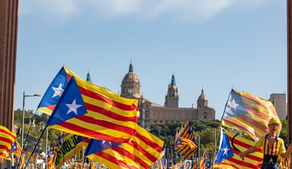 Catalan independentist flags waving in barcelona with the National Museum MNAC on background