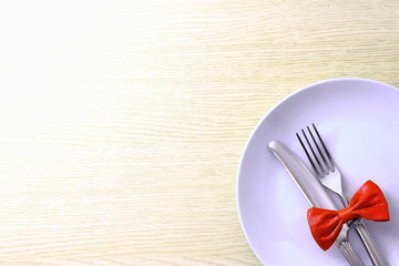 White plate with fork and knife on table