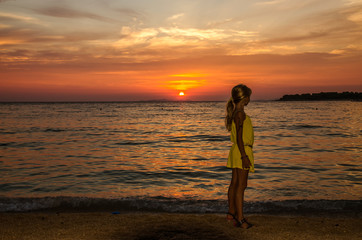 Fototapeta na wymiar silhouette of girl and colorful orange sunset