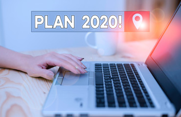Conceptual hand writing showing Plan 2020. Concept meaning detailed proposal doing achieving something next year woman with laptop smartphone and office supplies technology
