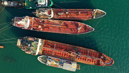 Aerial photo of shipwreck abandoned to rust in industrial bay of Elefsina, Attica, Greece