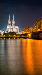 Fototapeta na wymiar The Hohenzollern Bridge over the Rhine River and Cologne Cathedral by night