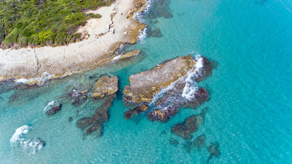 Aerial view of rock formations in blue waters of Adriatic Sea, on picturesque Puglia coast, near Baia dei Turchi, southern Italy . - 299416119