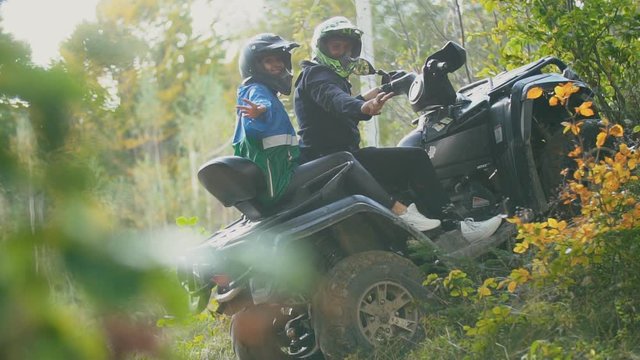 young couple sitting on a quad bike