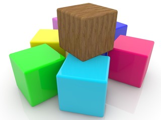 Fototapeta premium Wood toy cube between colored toy cubes